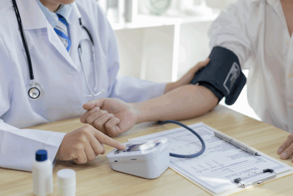 Doctor measuring blood pressure of a patient.