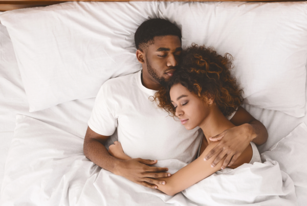 A couple lays peacefully in bed together because they listen to the other’s observations about their sleep.