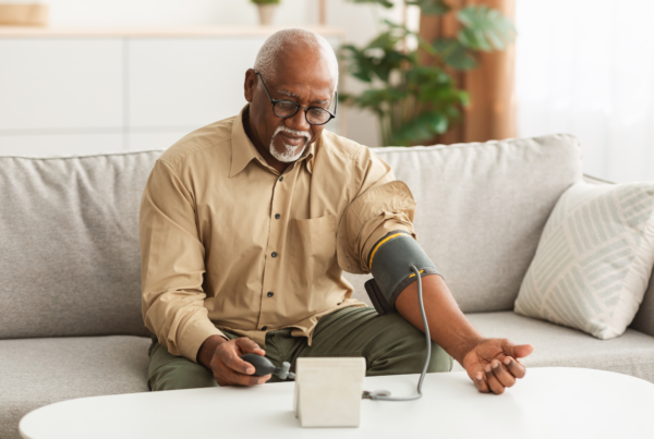 An older gentleman checks his blood pressure because he has been feeling generally fatigued and doesn’t know why.