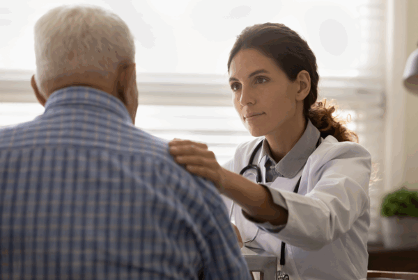 Doctor having serious discussion with middle-aged male patient.