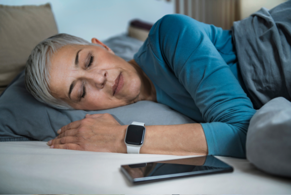 Woman sleeps peacefully wearing smartwatch.