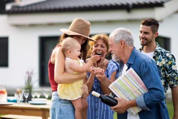 Multigenerational family gathers outdoors, illustrating how family history can affect heart-disease risk.
