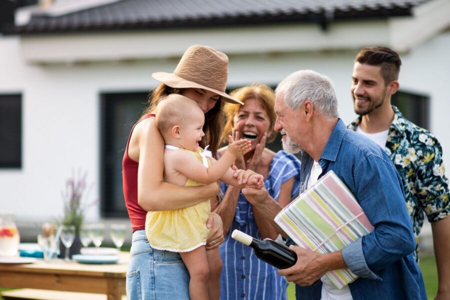 Multigenerational family gathers outdoors, illustrating how family history can affect heart-disease risk.
